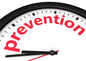 Time for prevention, health and safety lifestyle concept with a clock and prevention word and sign printed in red 3d render image.